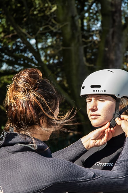 And instructor helping a student prepare for her lesson in Plouharnel
